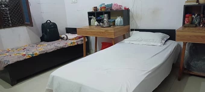 Spacious Boys PG room with bed and furniture